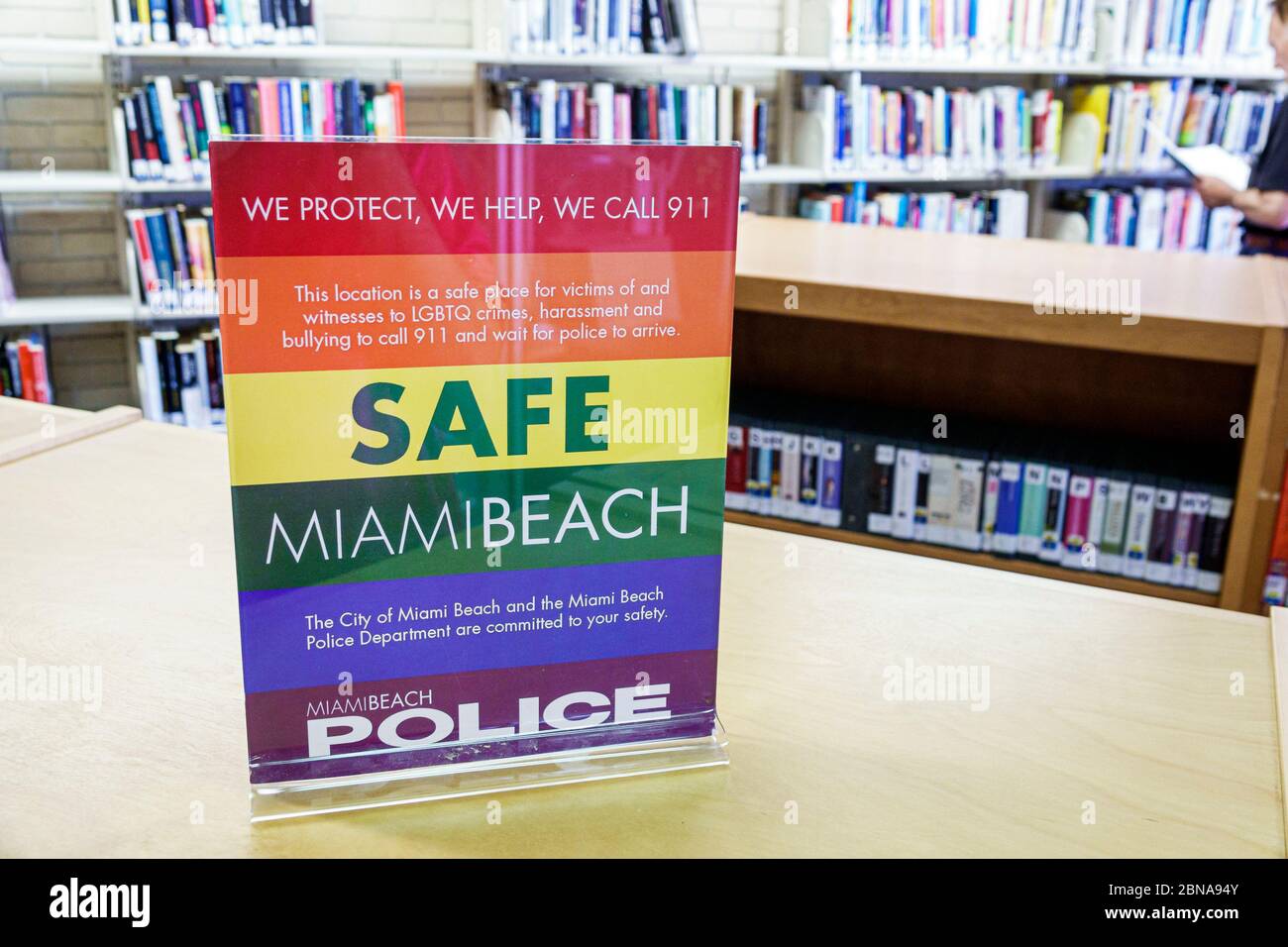 Miami Beach Florida,North Shore Public Library,sign safe place LGBTQ victims witnesses hate crimes,harassment bullying call 911 police,community safet Stock Photo