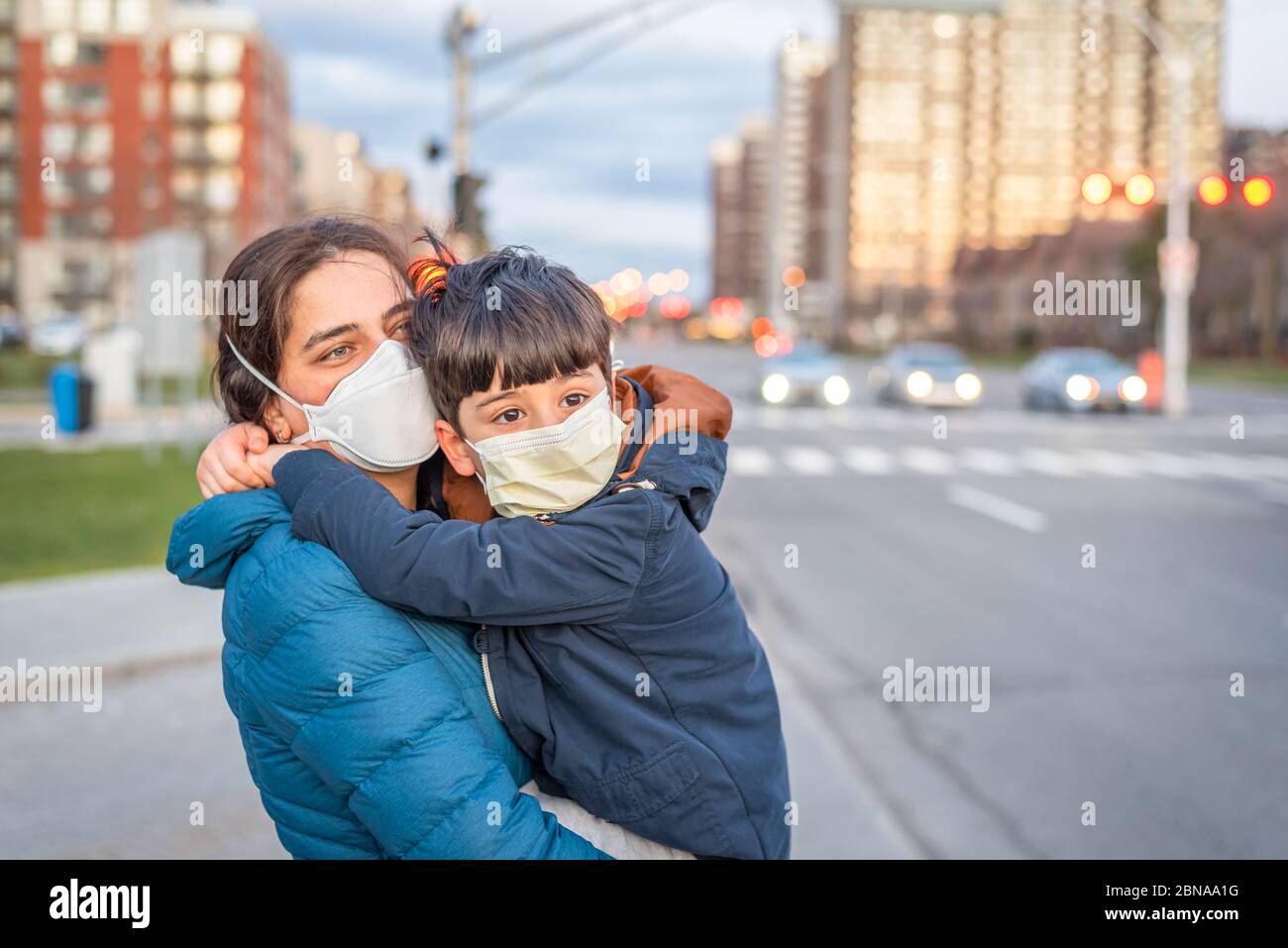 Novel coronavirus COVID-19 changed our life in society, mother and son going out to play ground wearing face mask Stock Photo