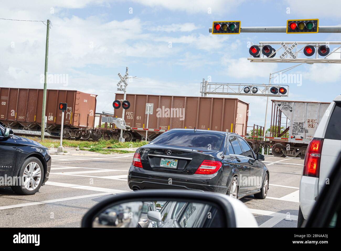 Miami Florida,railroad crossing gates down passing train,stopped