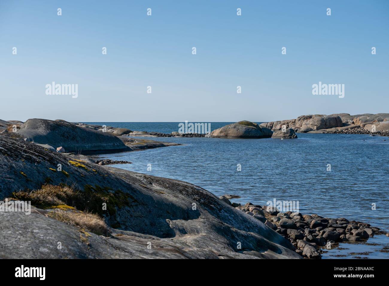Beautiful shot of a small lagoon surrounded by rocks on a sunny day ...