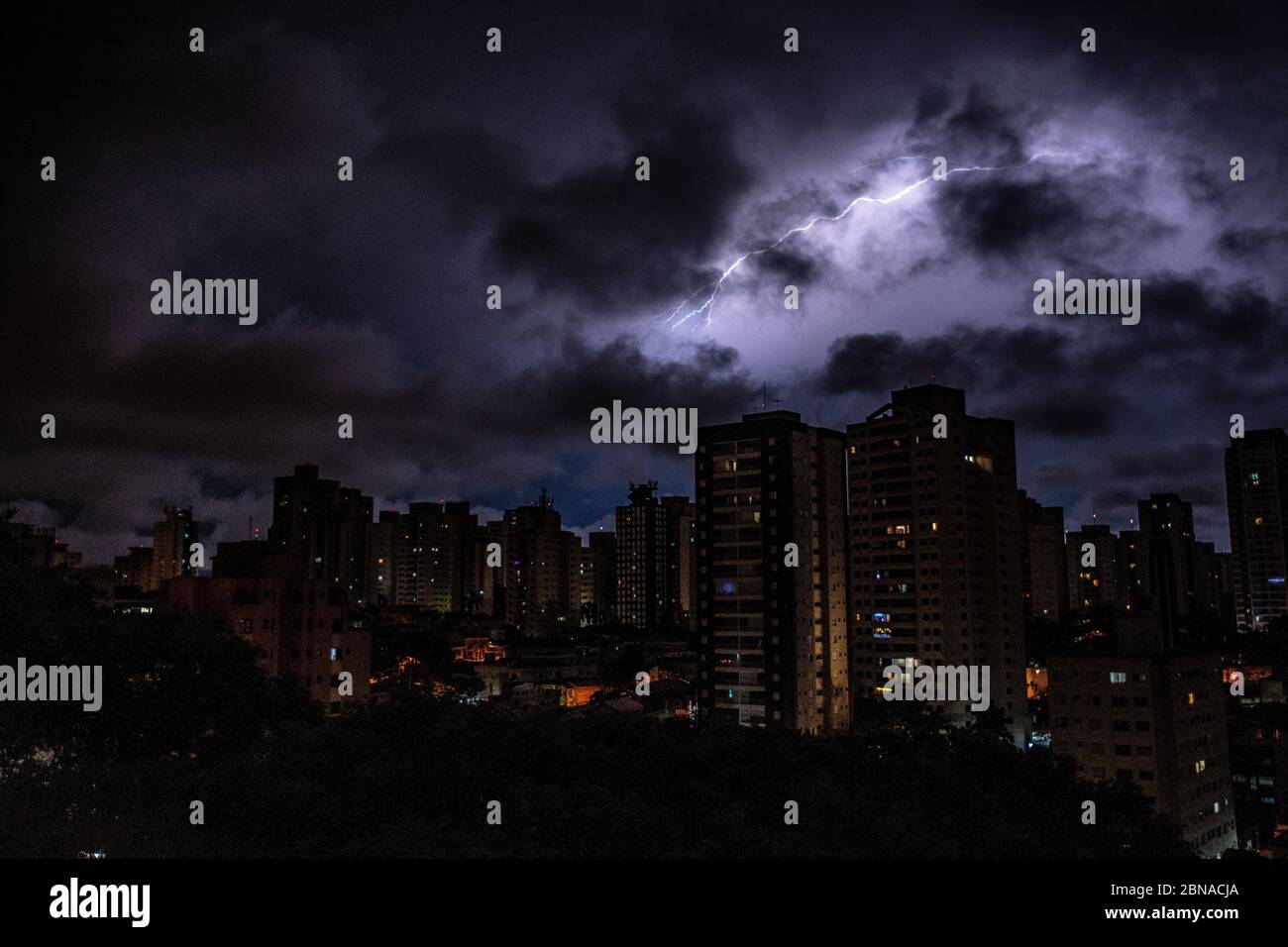 Amazing Shot Of A Cityscape On Dark Clouds And Lightning Background Stock Photo Alamy