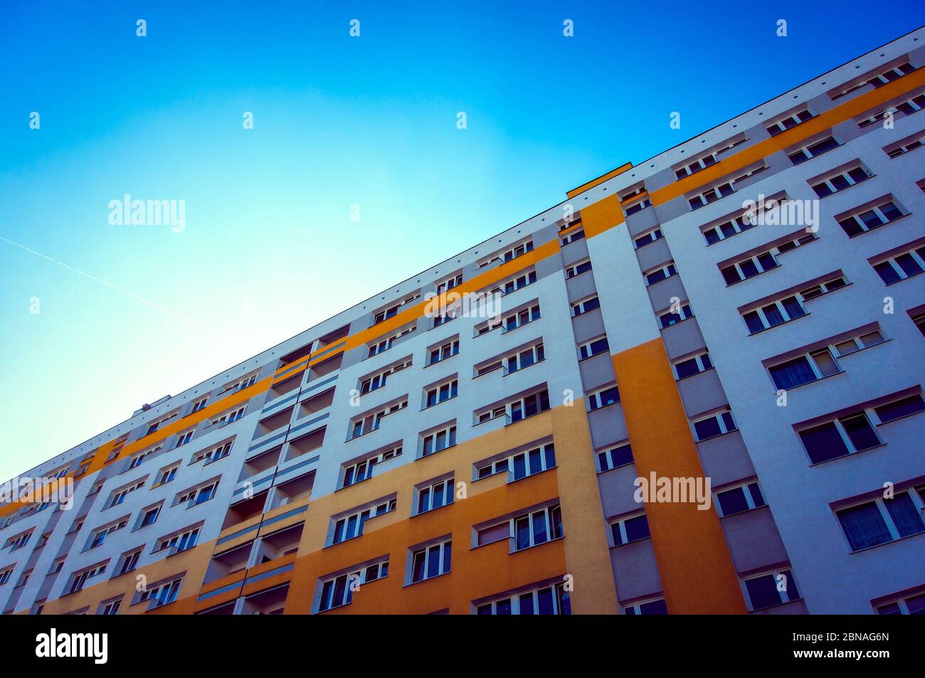 Low angle shot of a building, bright blue sky above Stock Photo - Alamy