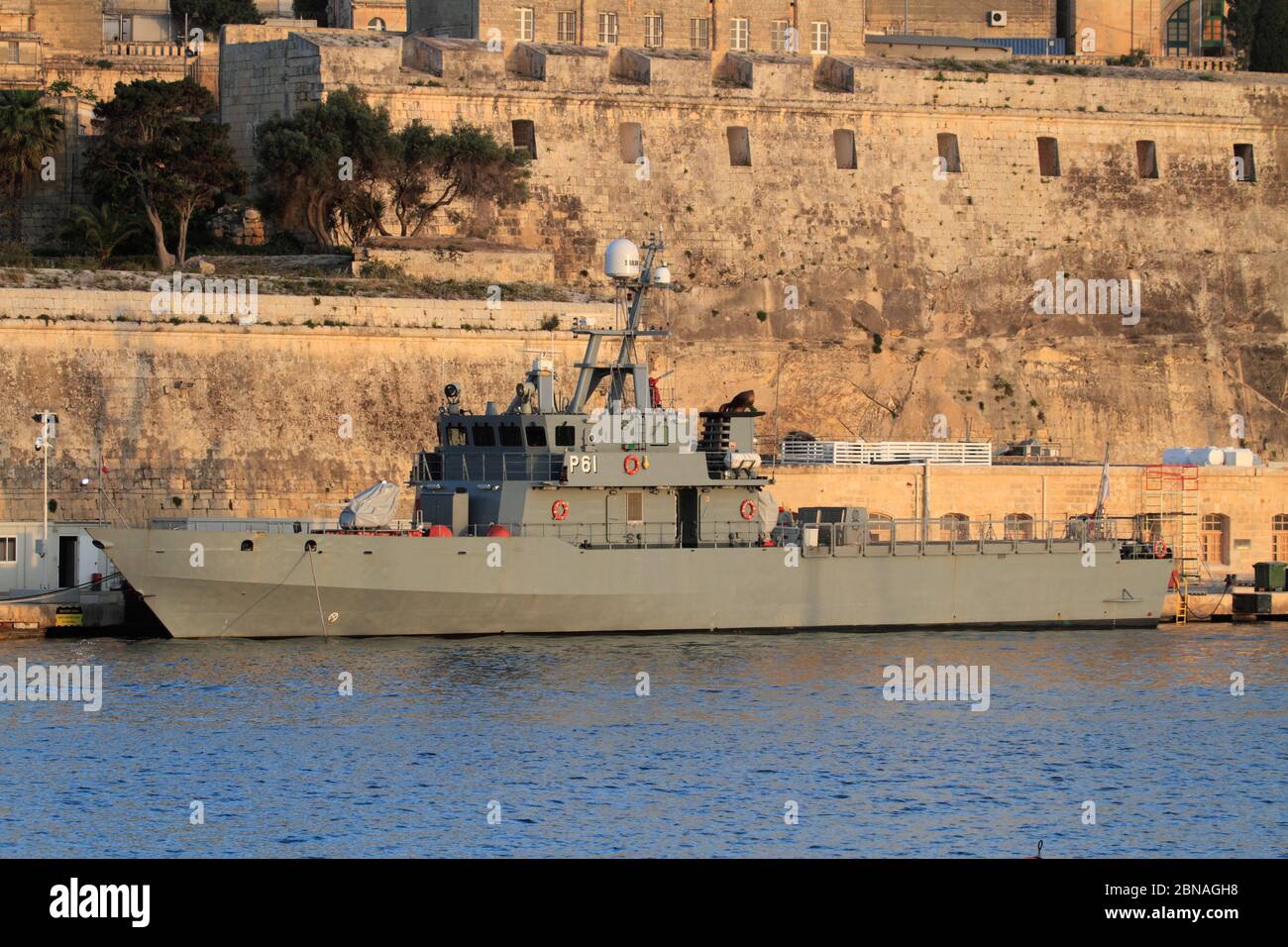 Armed Forces of Malta large patrol boat P61 moored at the AFM naval base at Hay Wharf, beneath the fortifications of Floriana Stock Photo