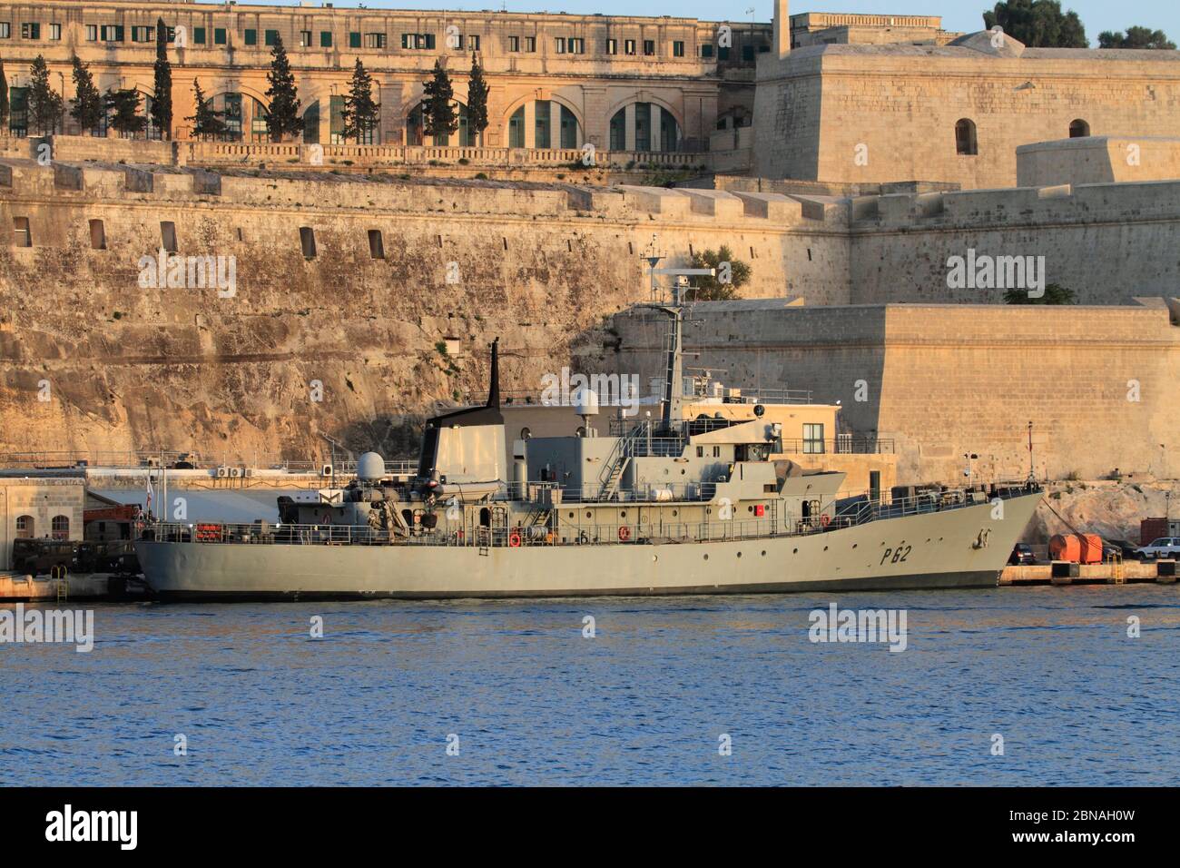 Armed Forces of Malta large patrol boat P62 moored at the AFM naval base at Hay Wharf, beneath the fortifications of Floriana Stock Photo