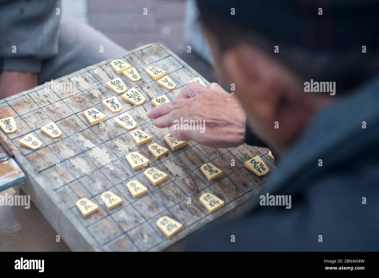Old men playing a game of Japanese chess called Shogi Stock Photo