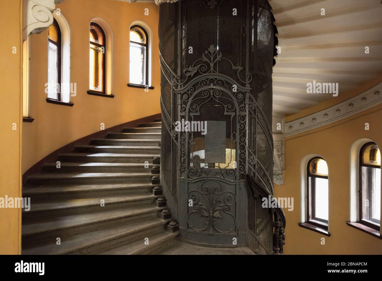 St. Petersburg, Russia - October 25, 2014: The main staircase round interior with forged door of an elevator shaft Stock Photo