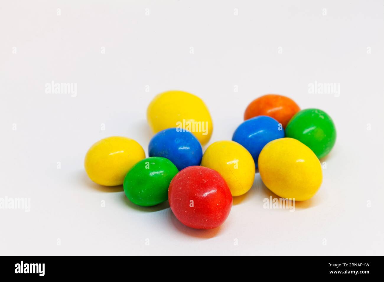 candy eggs in different colors before Easter Stock Photo