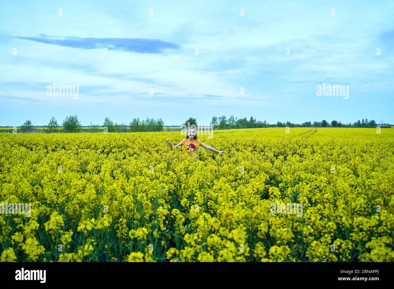 young girl in a rapeseed field Stock Photo - Alamy