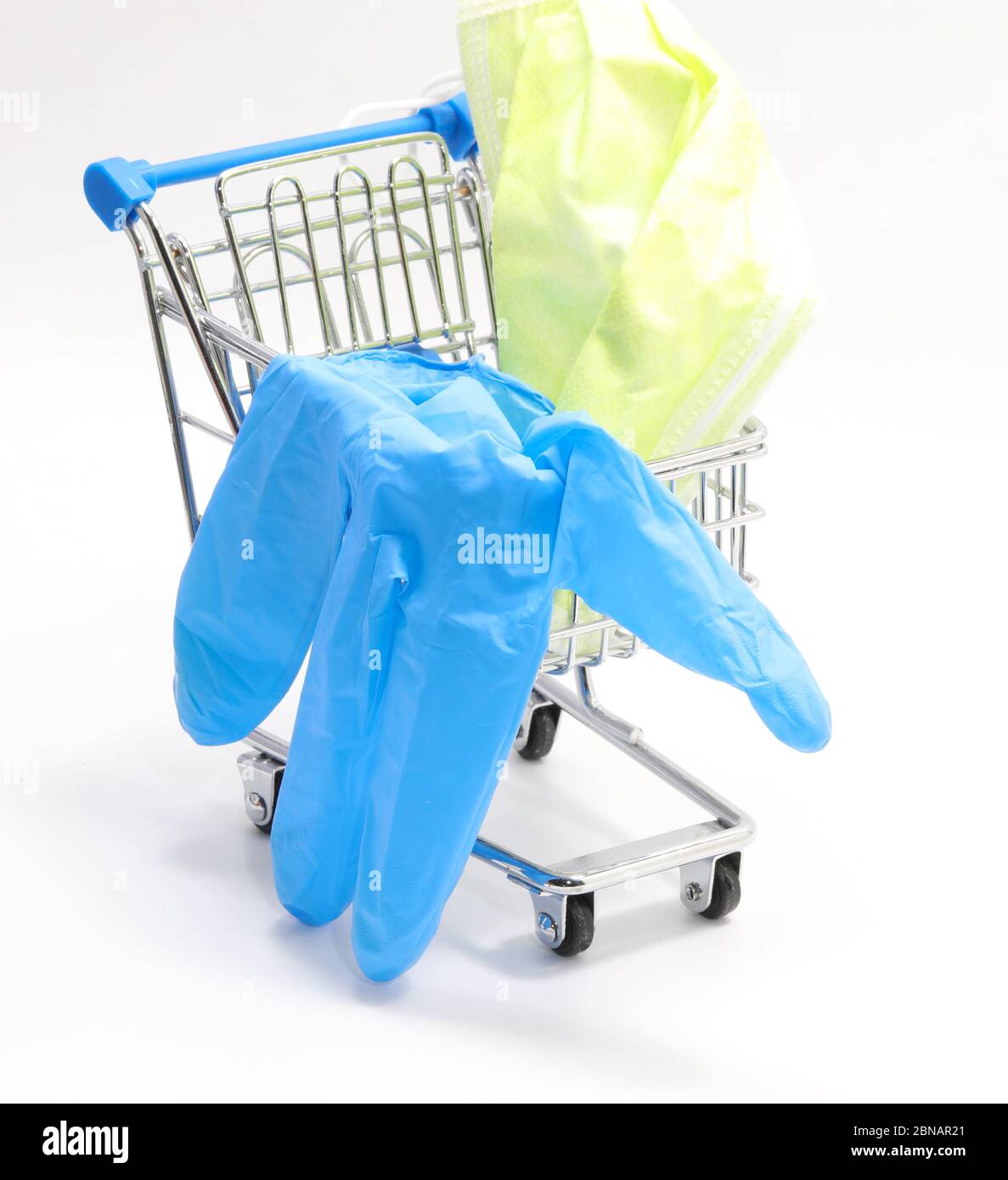 Medical equipments to defend against coronavirus in a small shopping trolley with mask and gloves on a white background Stock Photo