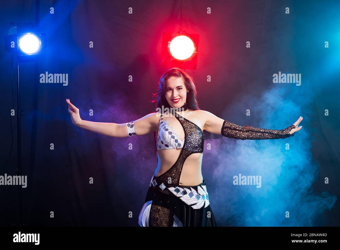 Young beauriful girl dancing tribal fusion belly dance isolated