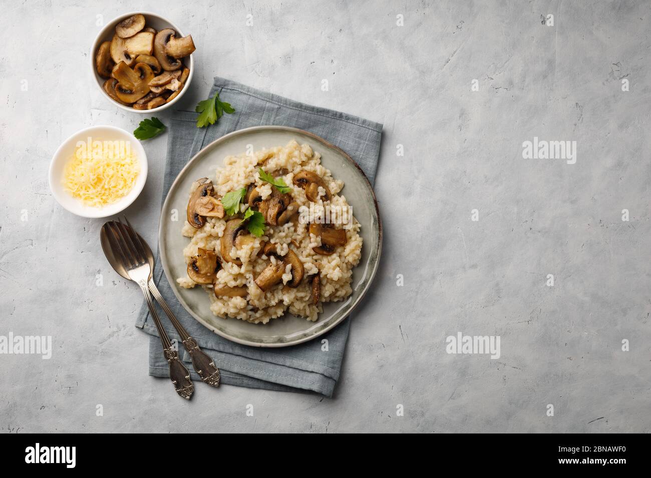 A dish of Italian cuisine - risotto from rice and mushrooms. Top view. Flat lay. Copy space. Stock Photo