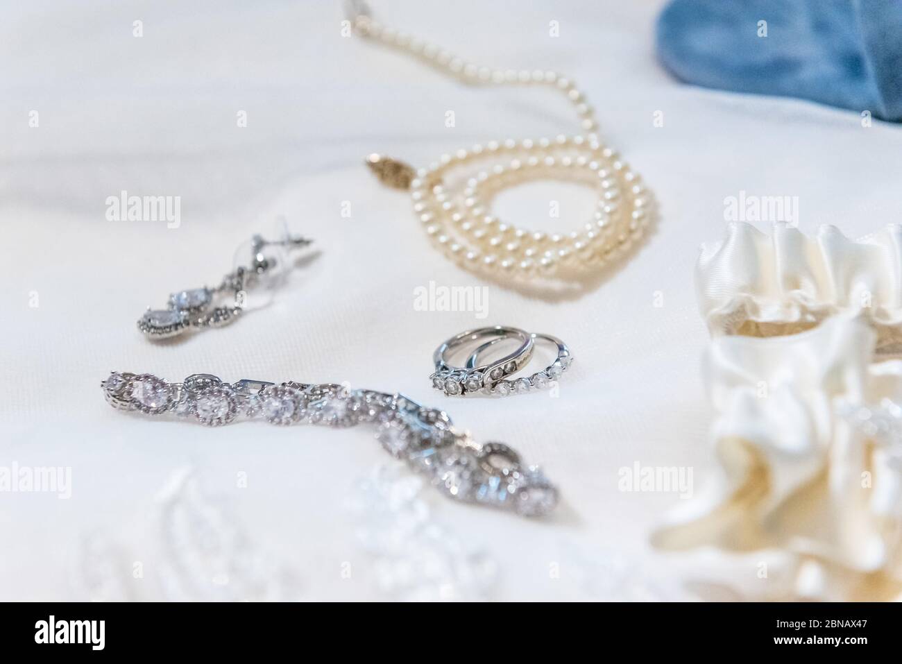 Closeup shot of precious accessories with diamond rings and bracelet and a pearl necklace Stock Photo