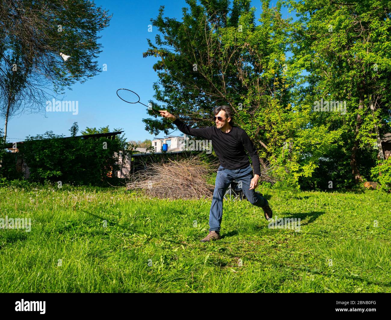 Guy play badminton outdoors on a beautiful summer day Stock Photo Alamy