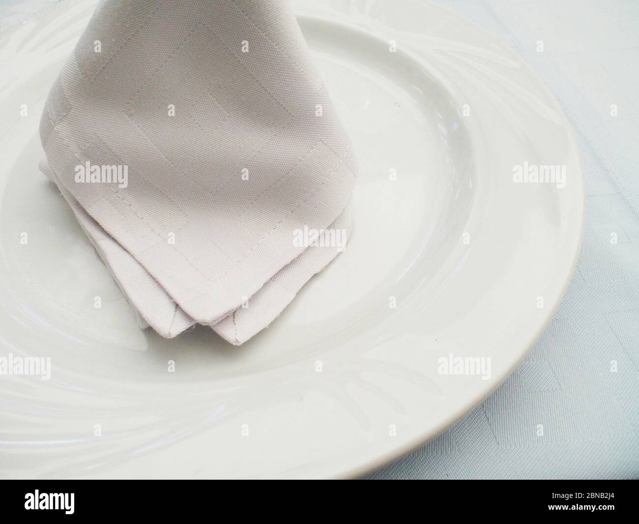 Napkin on empty plate. Stock Photo