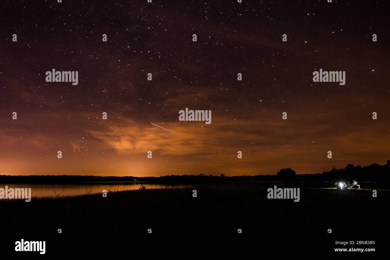 Breathtaking scenery of the night sky with a lot of stars over the lake ...
