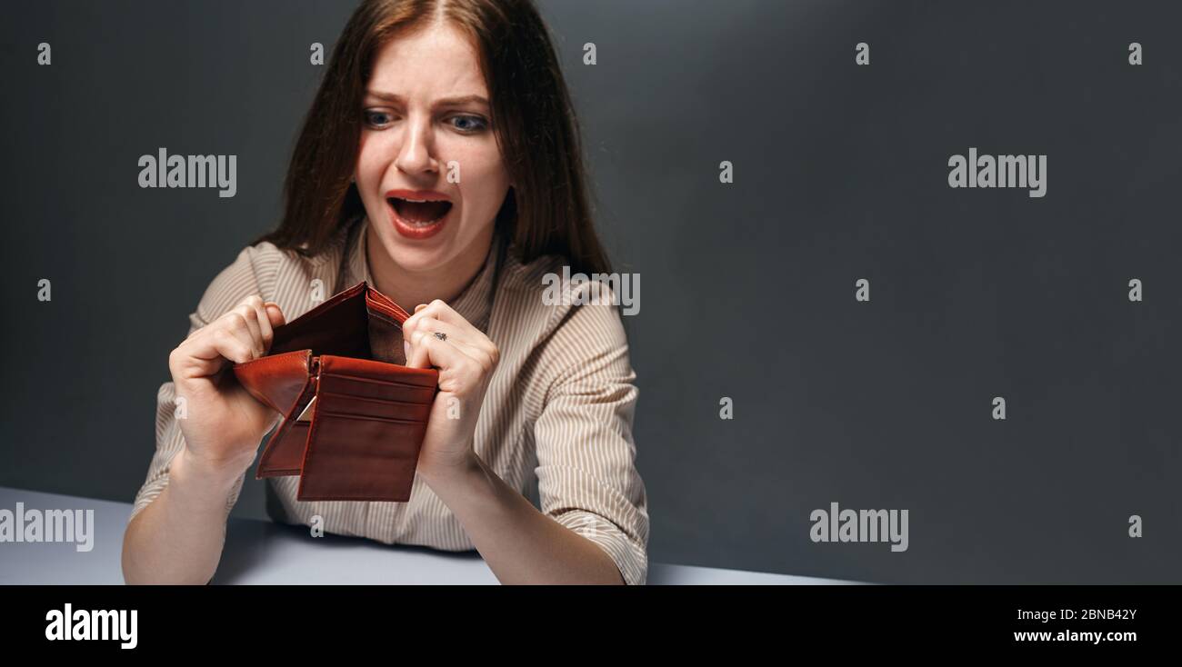Young woman shows her empty wallet. Bankruptcy concept Stock Photo - Alamy