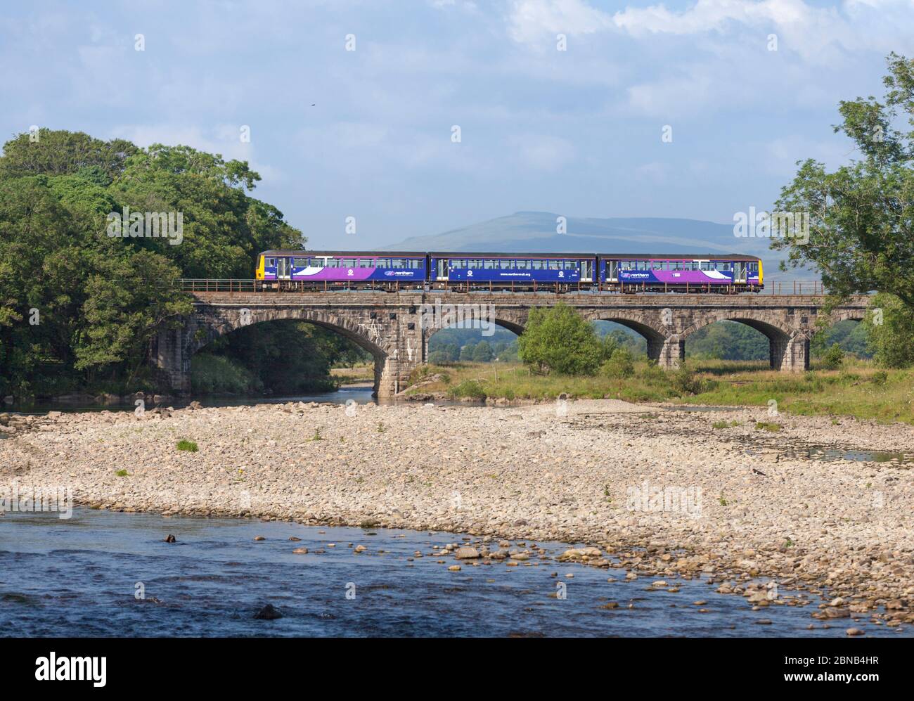 An Arriva Northern rail class 144 pacer train 144022 crosses the river ...