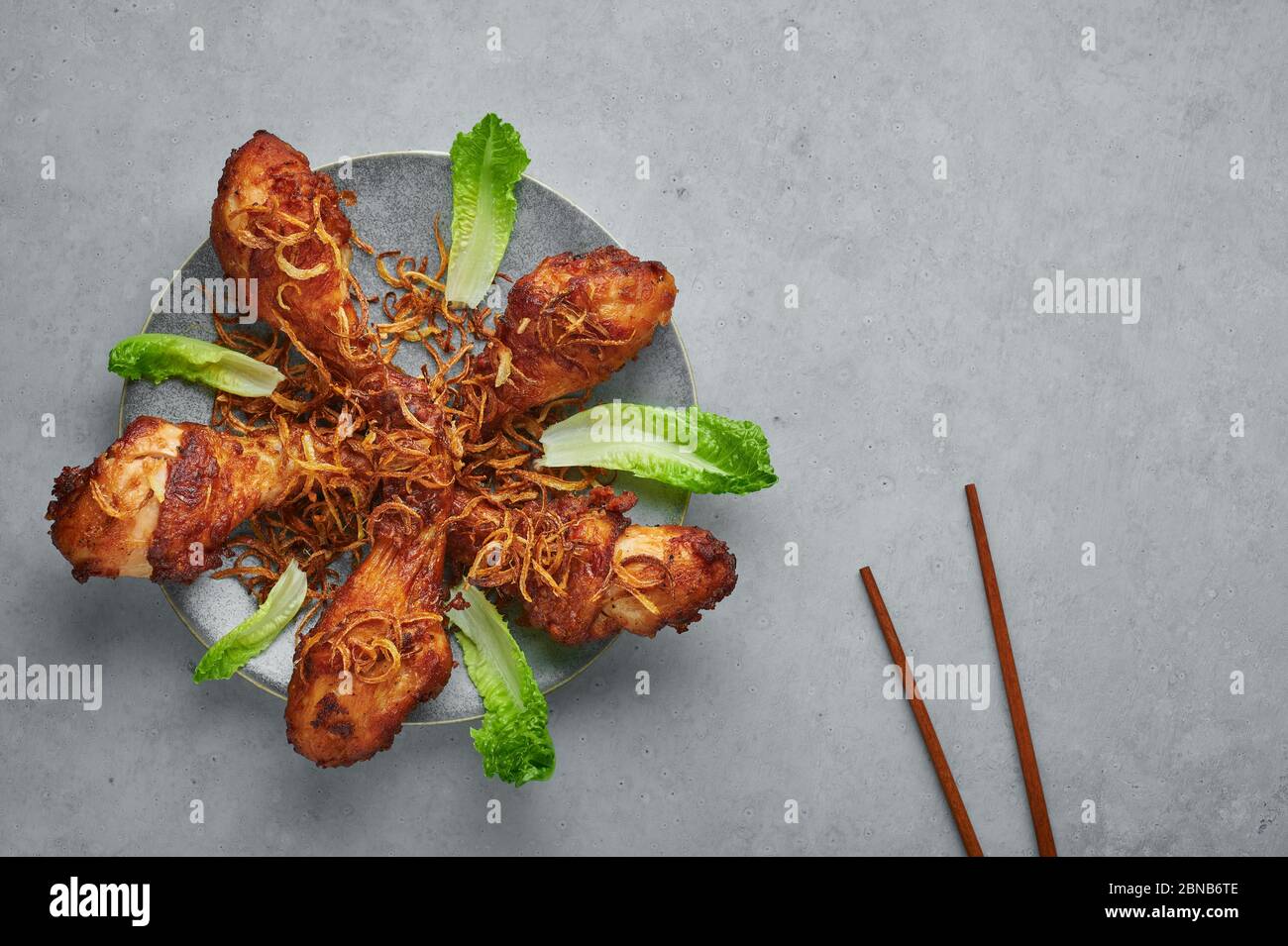 Gai Tod Hat Yai or Thai Deep Fried Chicken on gray plate on concrete ...