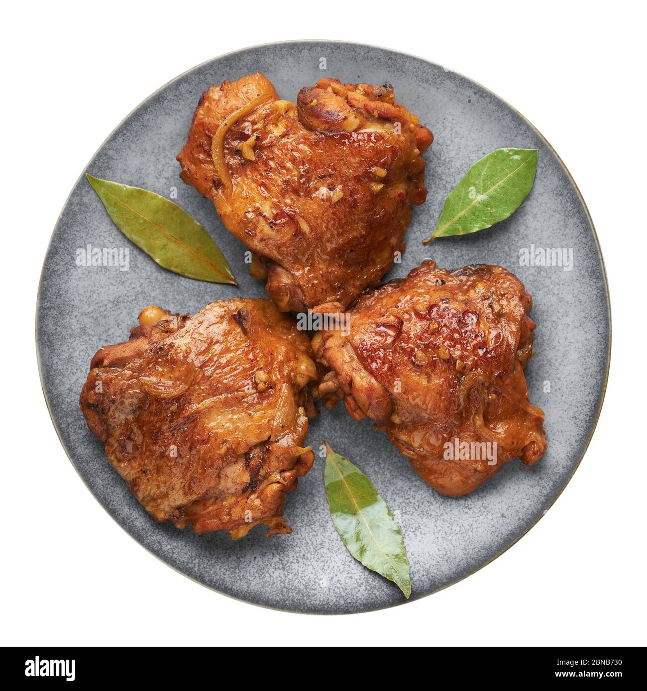 Filipino Chicken Adobo on gray plate isolated on white backdrop