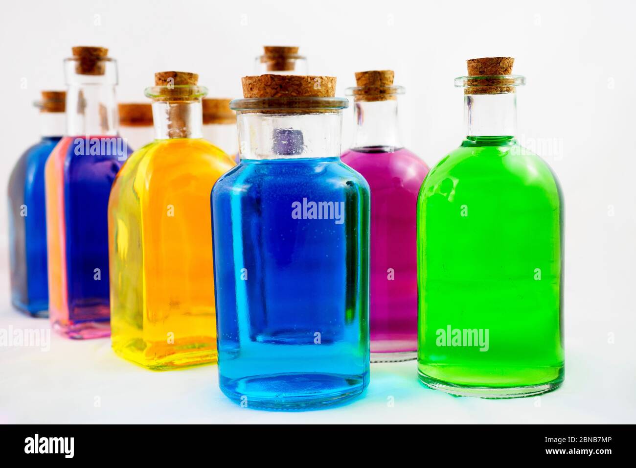 Coloured bottles in white background Stock Photo