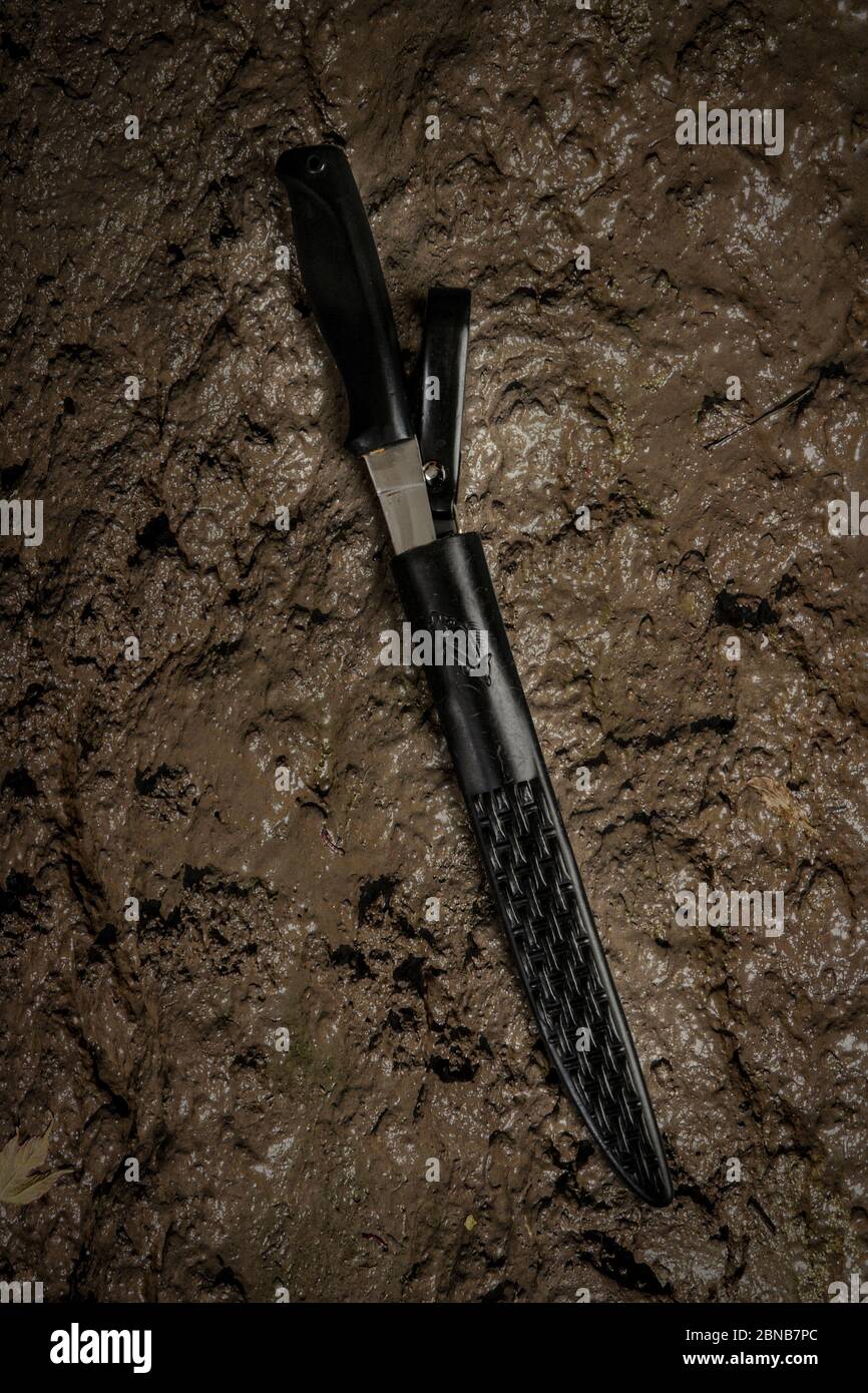 Knife and scabbard on a muddy background Stock Photo Alamy