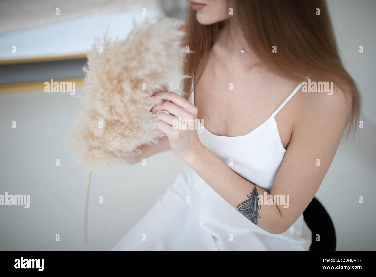 Wedding morning bride with peonies. wedding bouquet in the hands of the bride. lovely woman in a wedding dress Stock Photo