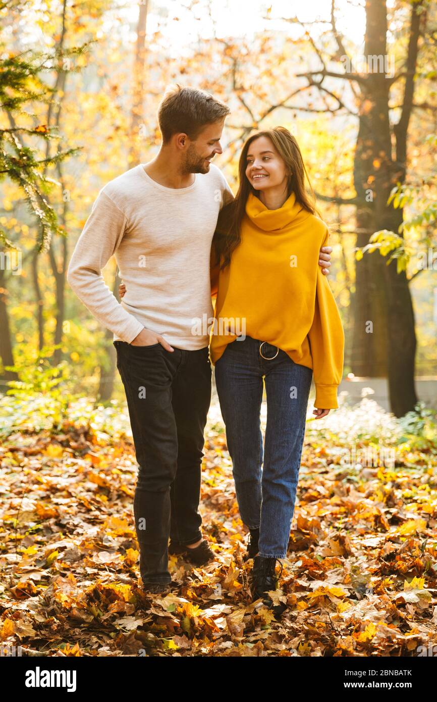 full-length-of-a-beautiful-young-couple-in-love-walking-at-the-autumn