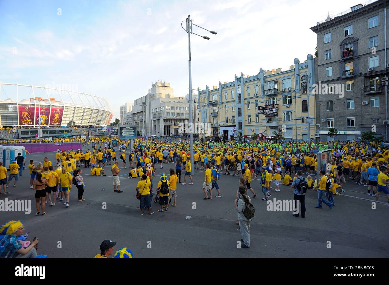 Swedish soccer fans in yellow color T-shirts and with national flags marching on the street supporting their football team. Euro-2012, Swedish camp. J Stock Photo