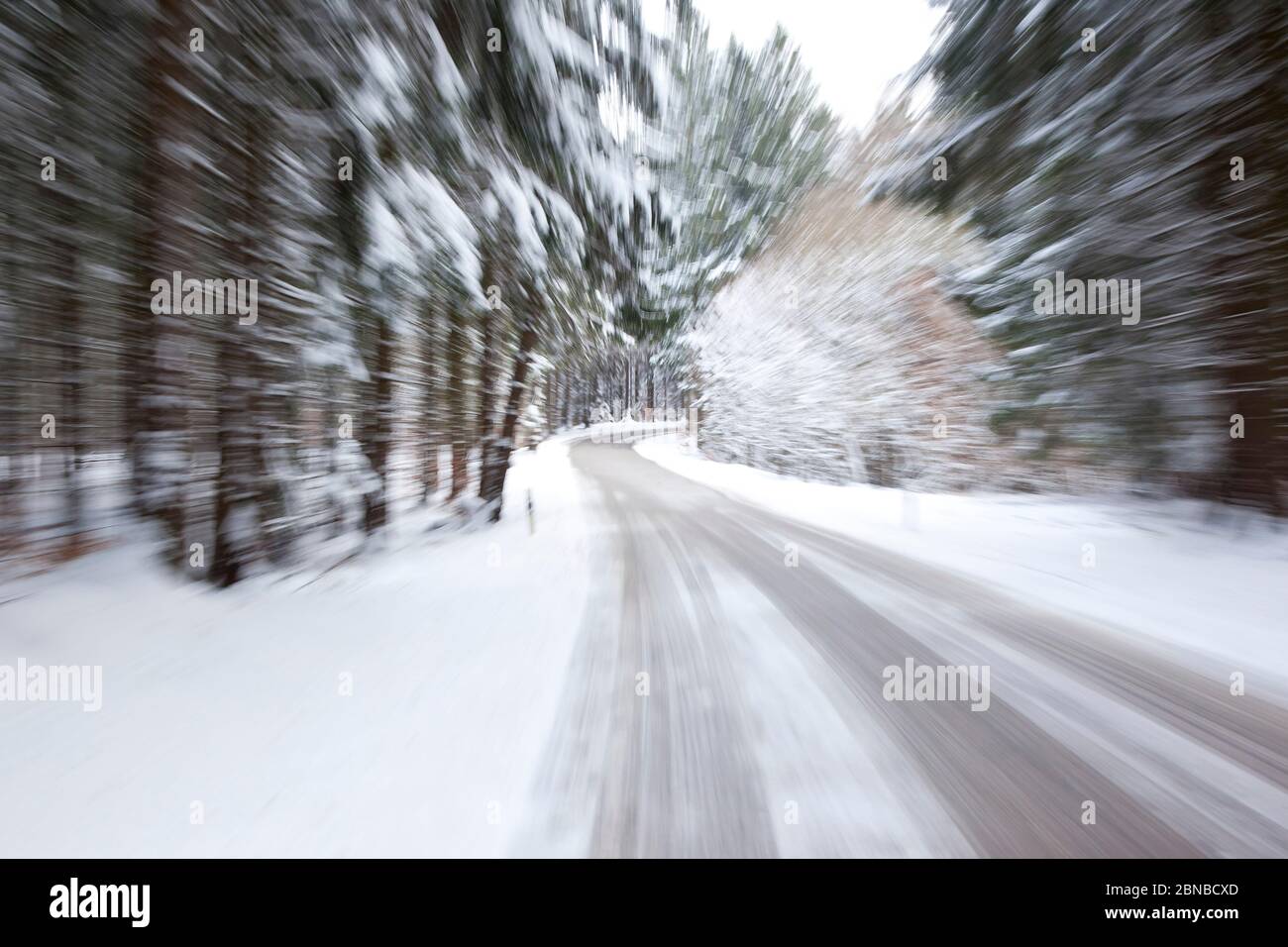 deep winter snowy road with a zoom, Germany, Bavaria Stock Photo