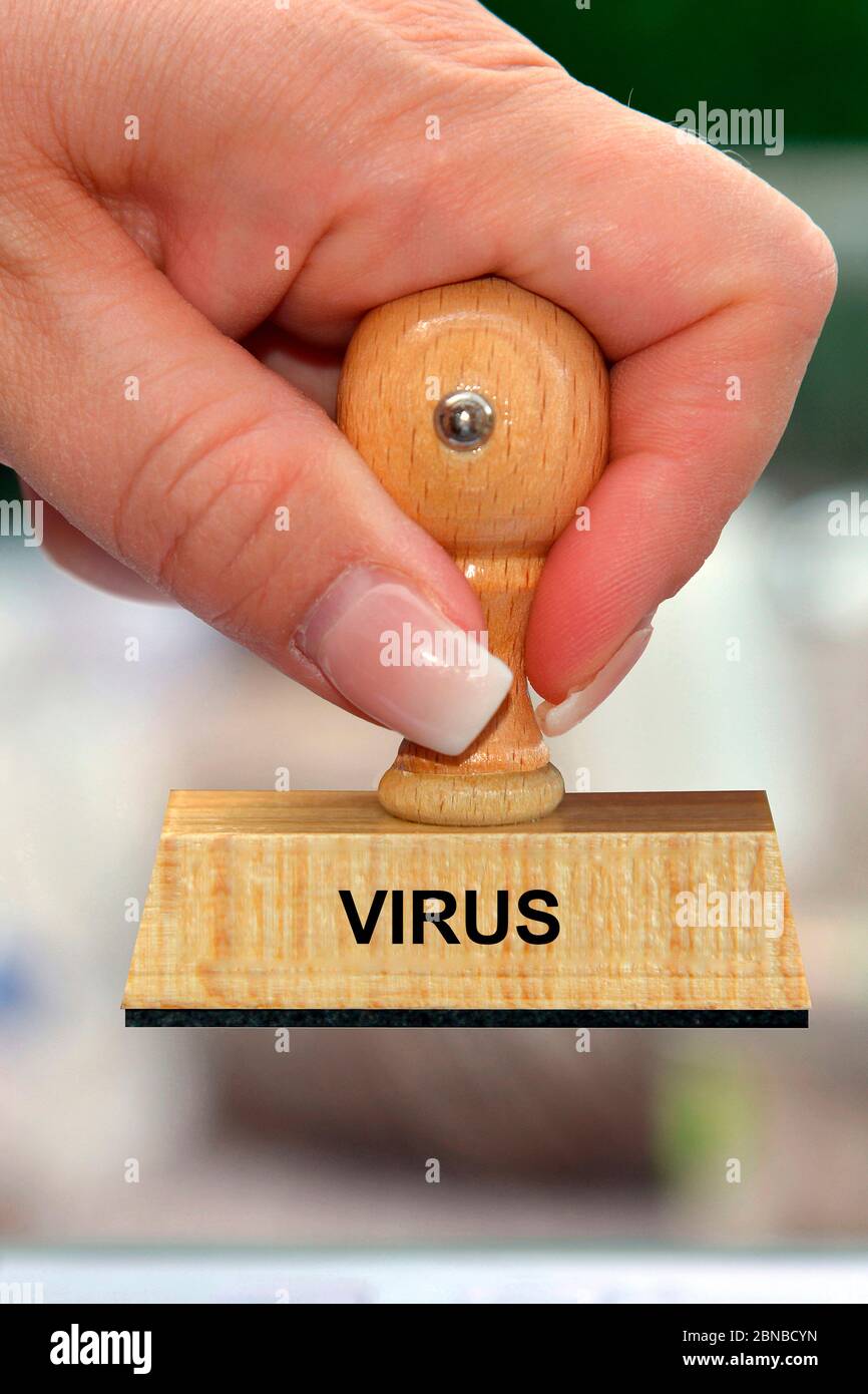 stamp in the hand of a woman lettering virus, Germany Stock Photo