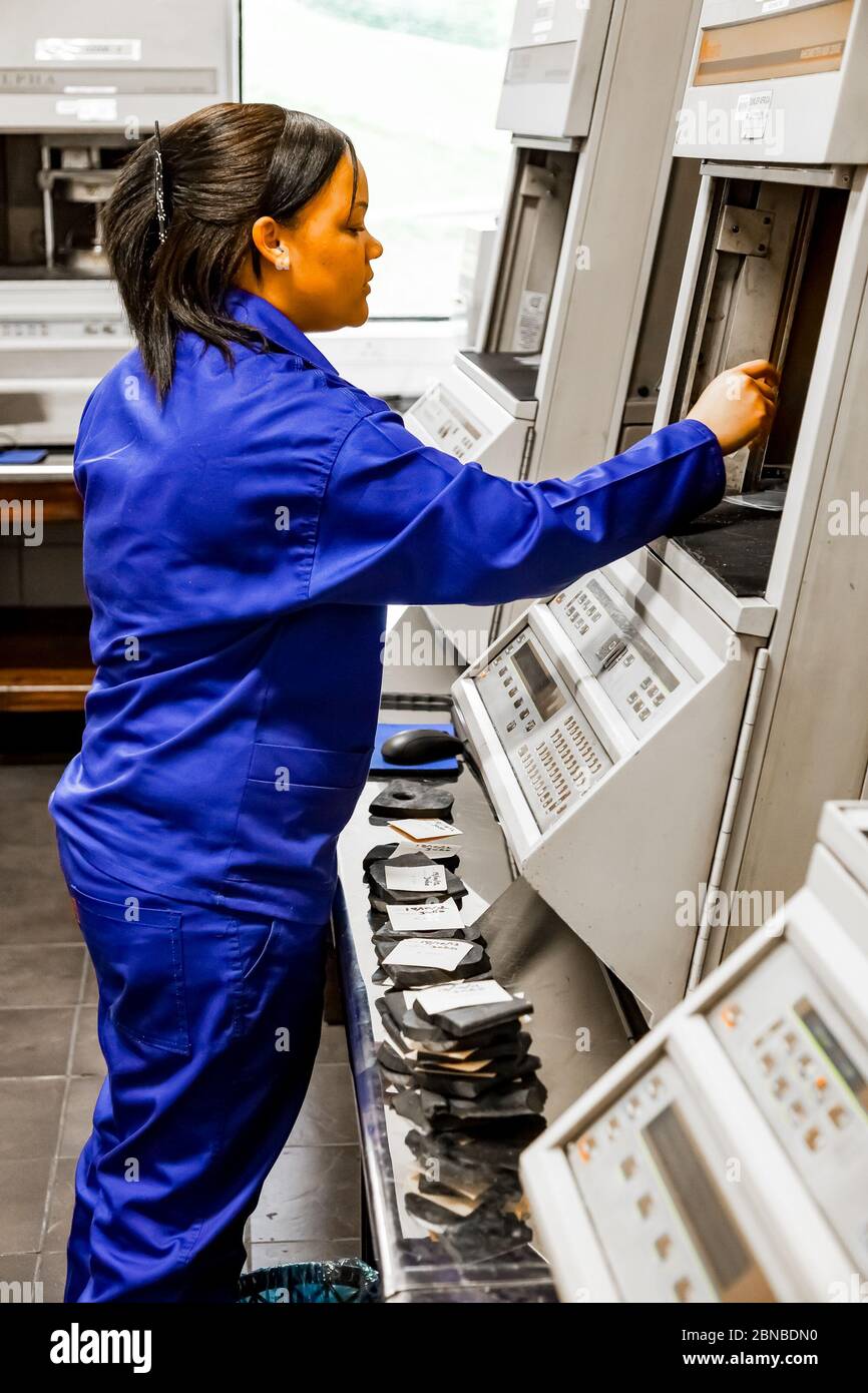 Johannesburg, South Africa - October 19, 2012: Female lab technician testing product samples in a rubber factory Stock Photo