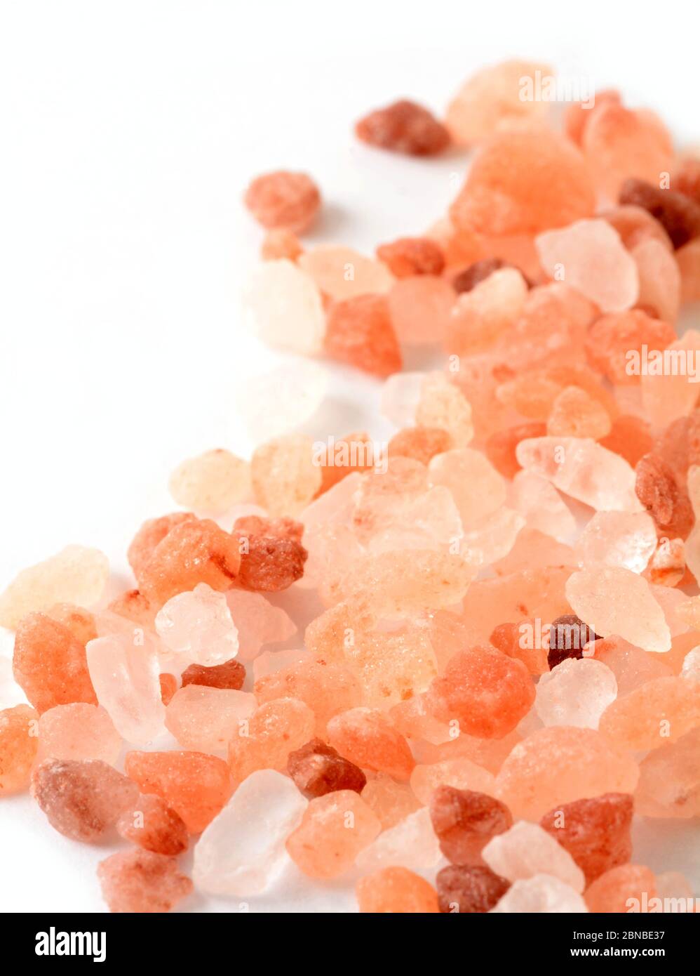Macro of Pink Himalayan Rock Coarse Salt on White Background Stock