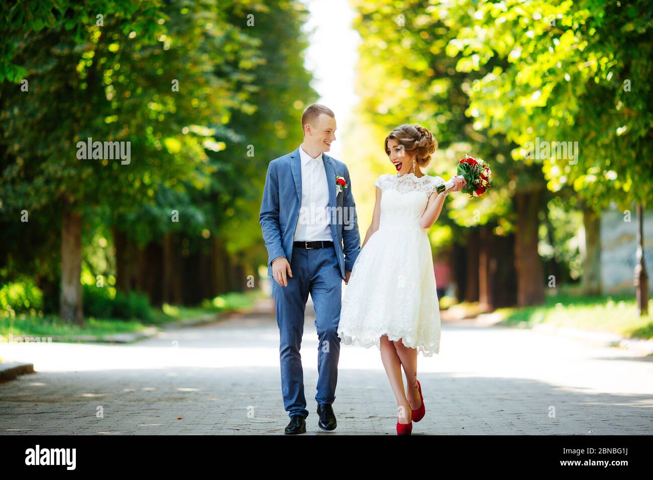 Wedding couple, happy newlyweds and husband hugging in green park Stock ...