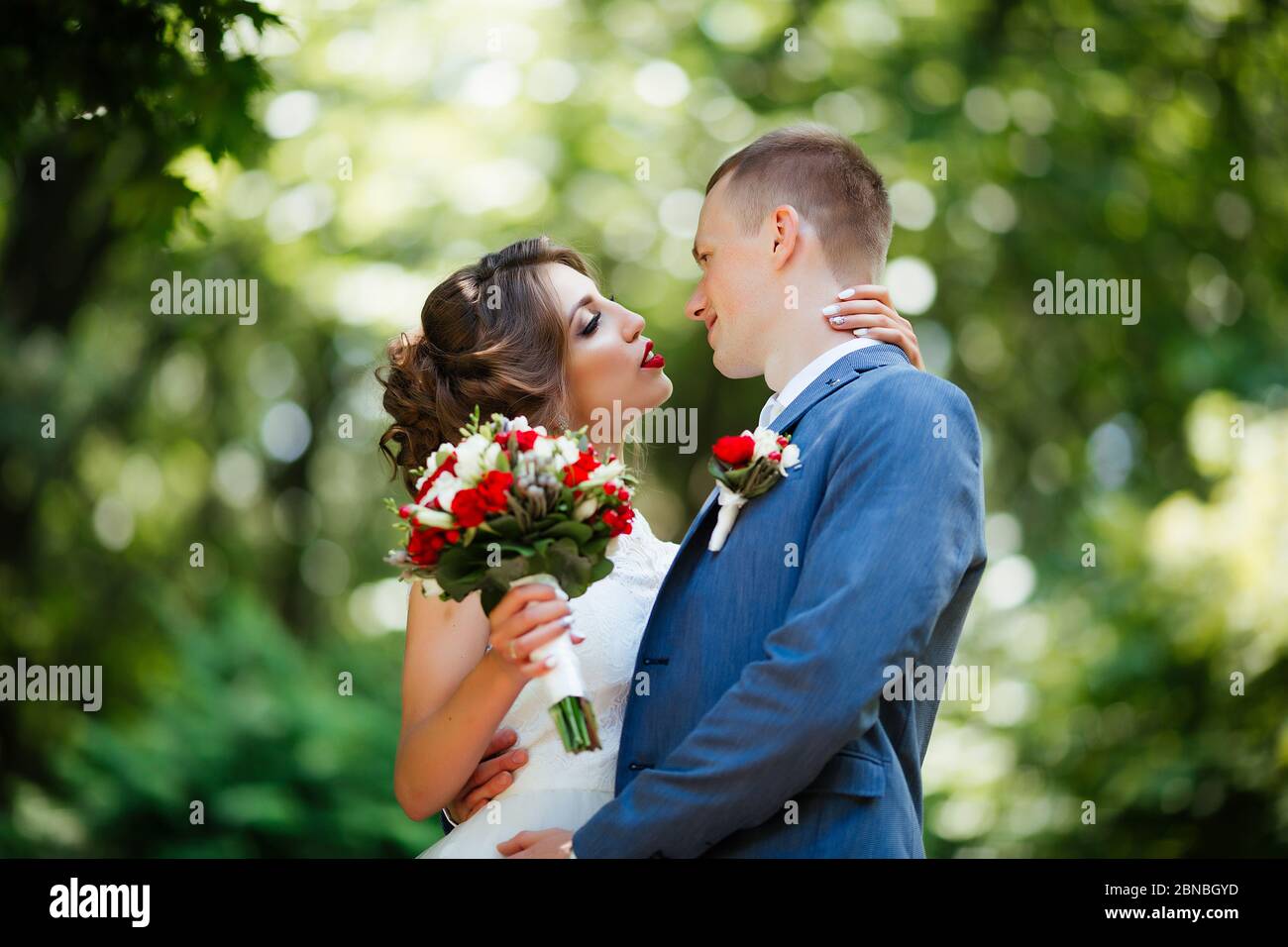 Wedding couple, happy newlyweds and husband hugging in green park Stock ...