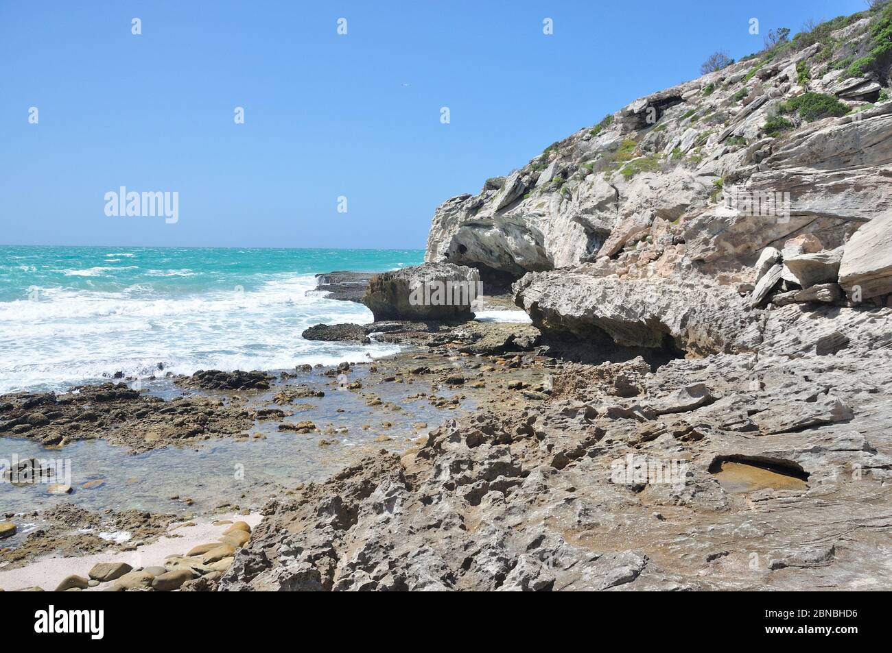 Rocky low-water path to entrance to 'Waenhuiskrans'cave near Arniston Western Cape. Stock Photo