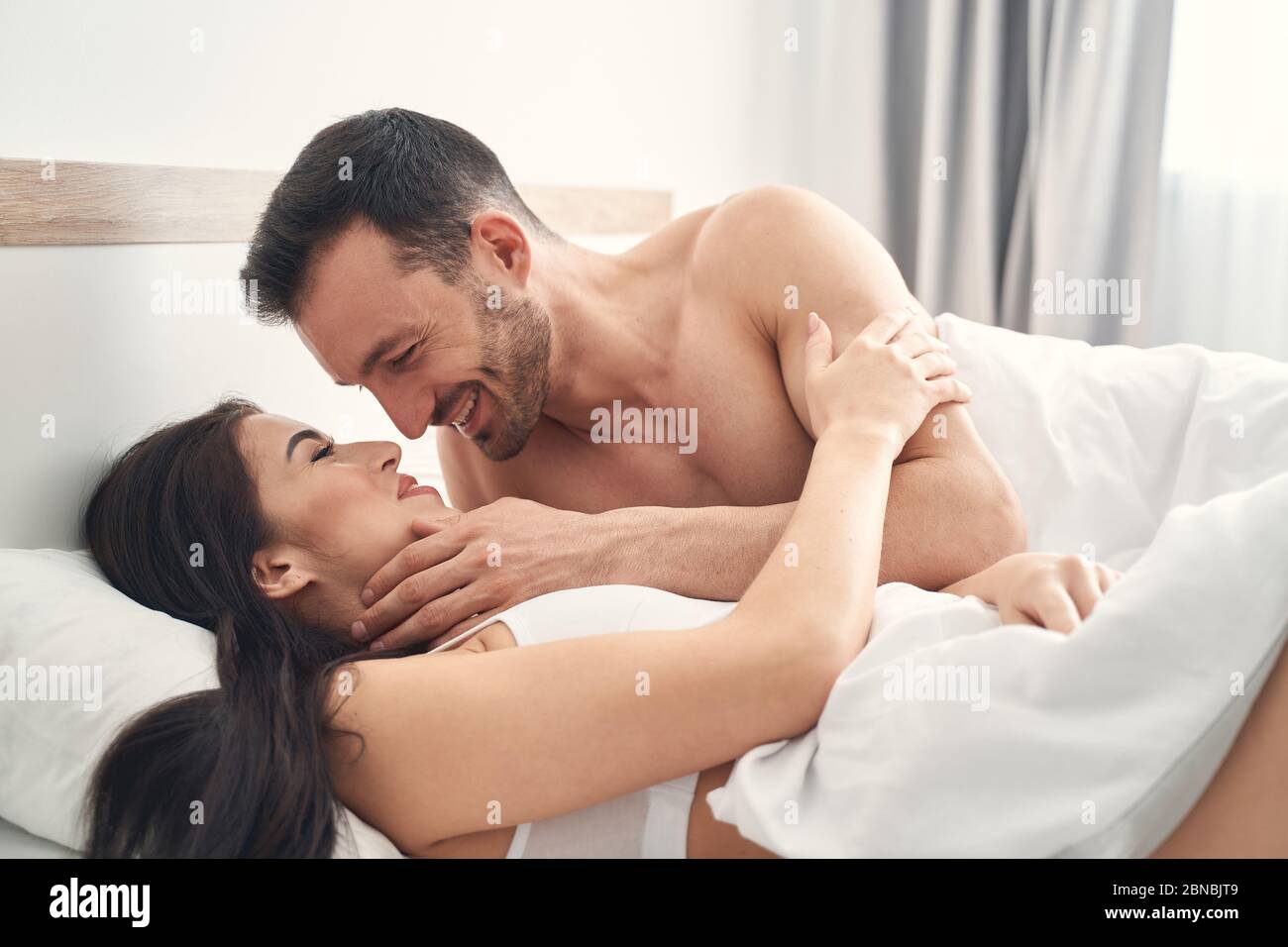 Man Opening Her Bra In Bedroom Stock Photo, Picture and Royalty