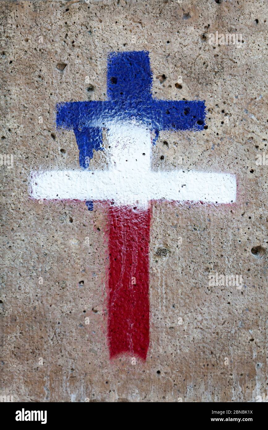 Paris, France - September 07 2016: Loraine cross painted in blue, white and red like the French flag on a wall. Stock Photo