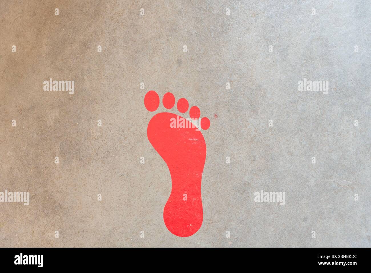 footprint of red person on the floor Stock Photo