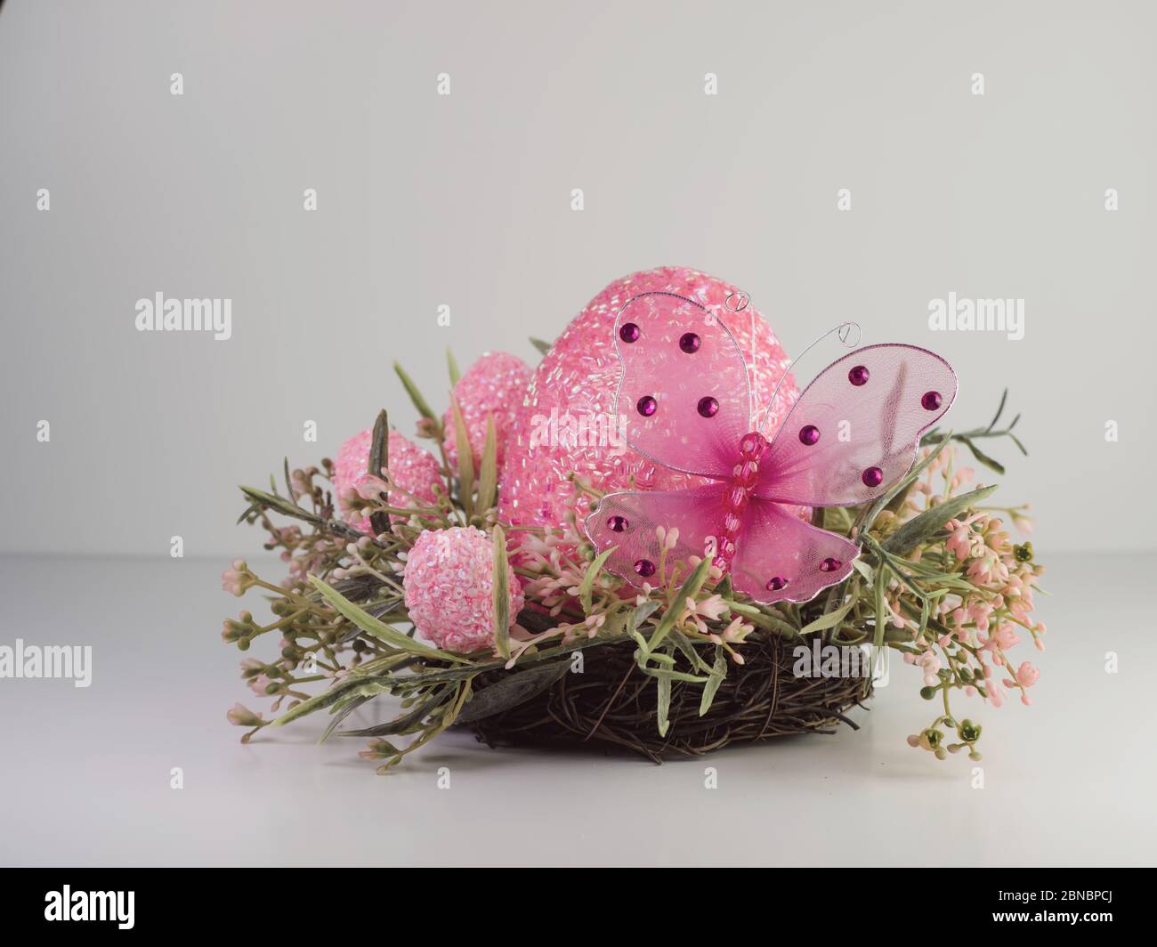 Pink decorative eggs and a butterfly for easter Stock Photo