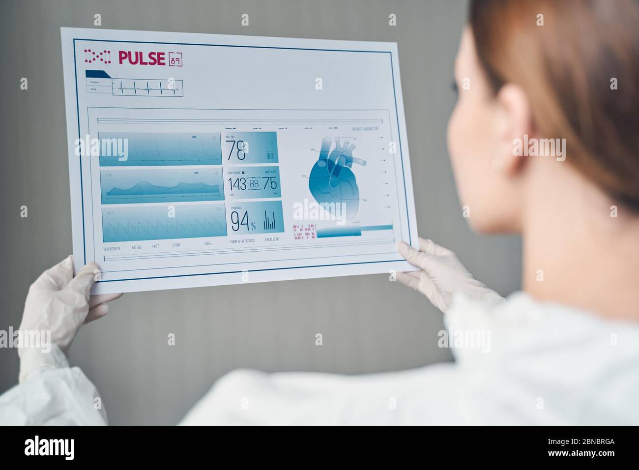 Young woman analyzing results of heart rate monitor Stock Photo