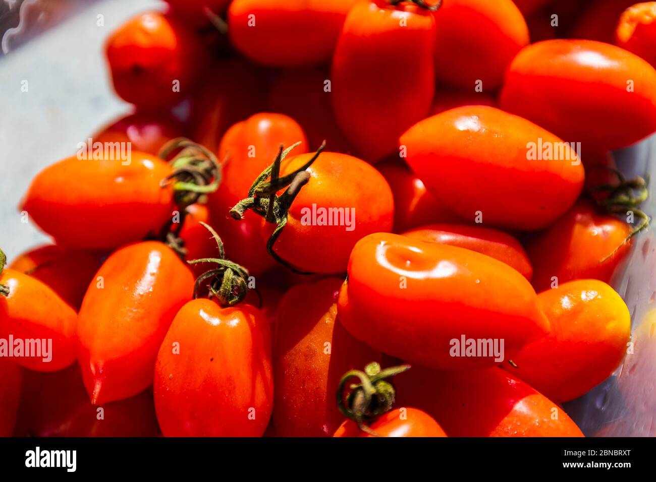 fresh cherry tomatoes in a glass bowl Stock Photo - Alamy