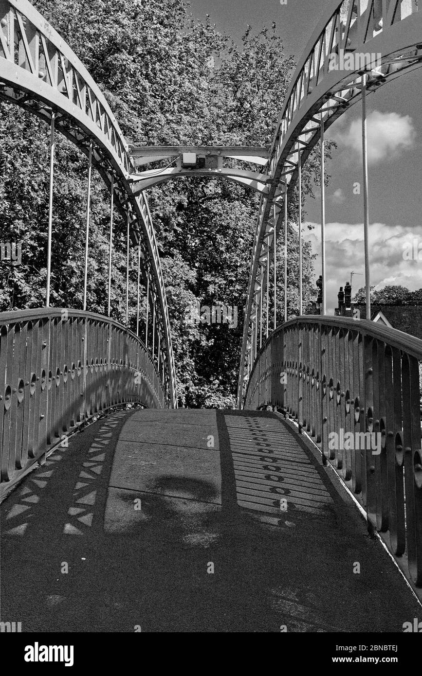 Shadows on the Suspension Bridge, Bedford, Bedfordshire, UK on a sunny day in Spring (black and white photo) Stock Photo