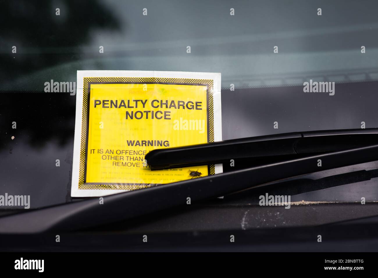 A Parking fine under the windscreen wiper of a car, London Stock Photo