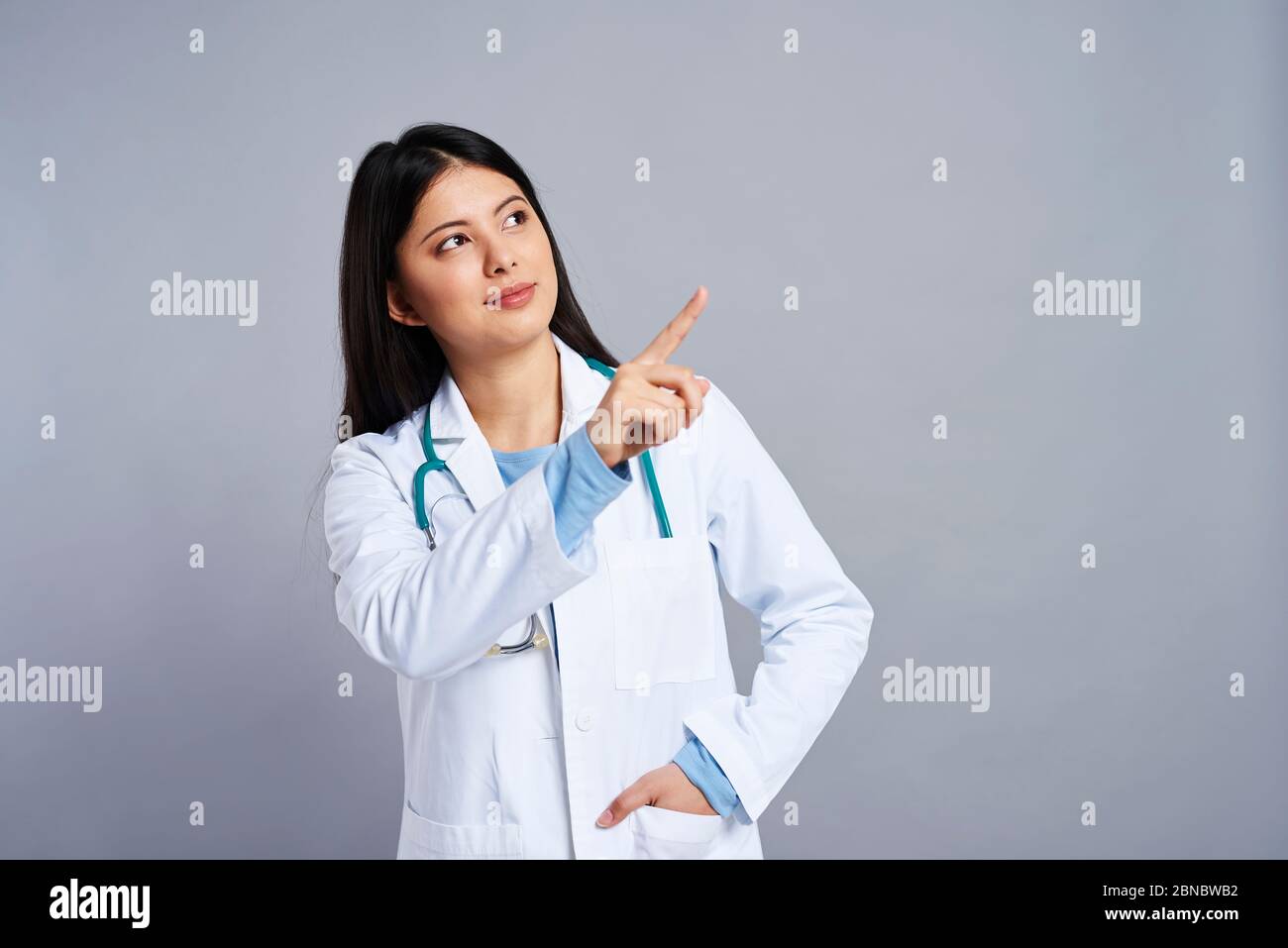 Female doctor pointing at the space Stock Photo