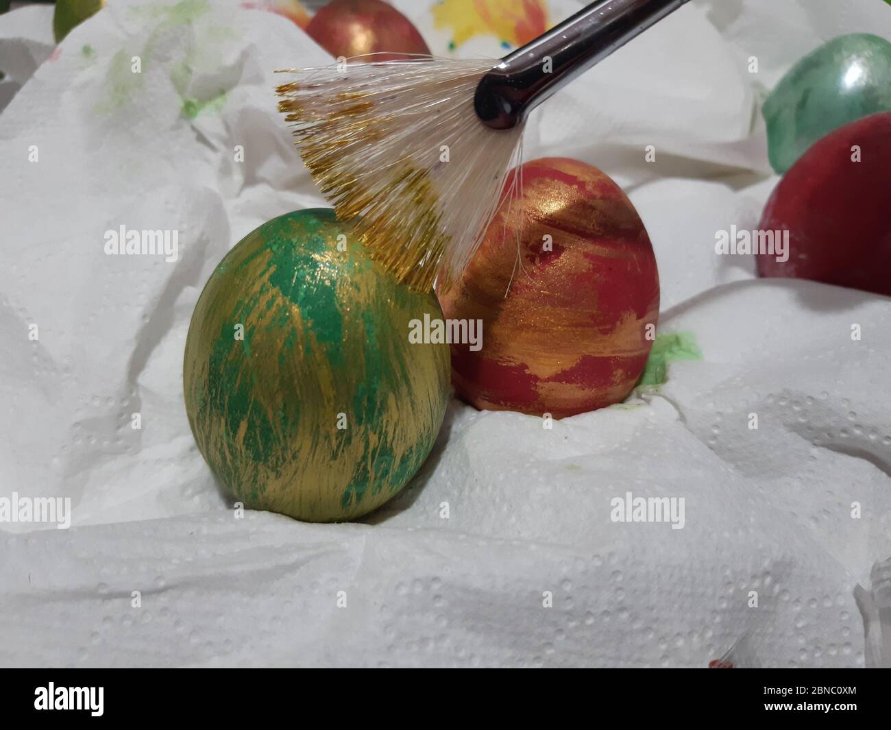High angle closeup shot of a person coloring Easter eggs on a white fabric Stock Photo - Alamy