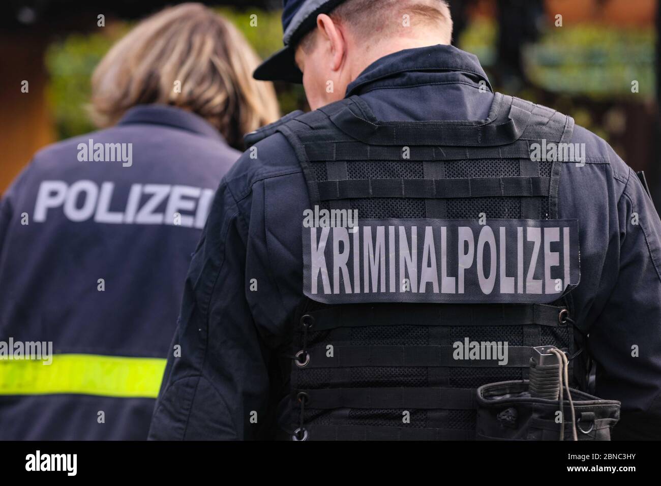 Dresden, Germany. 13th May, 2020. Two police officers from behind with the inscription "Kriminalpolizei und Polizei" on their backs stand shifted at the scene of action. Credit: Tino Plunert/dpa-Zentralbild/ZB/dpa/Alamy Live News Stock Photo