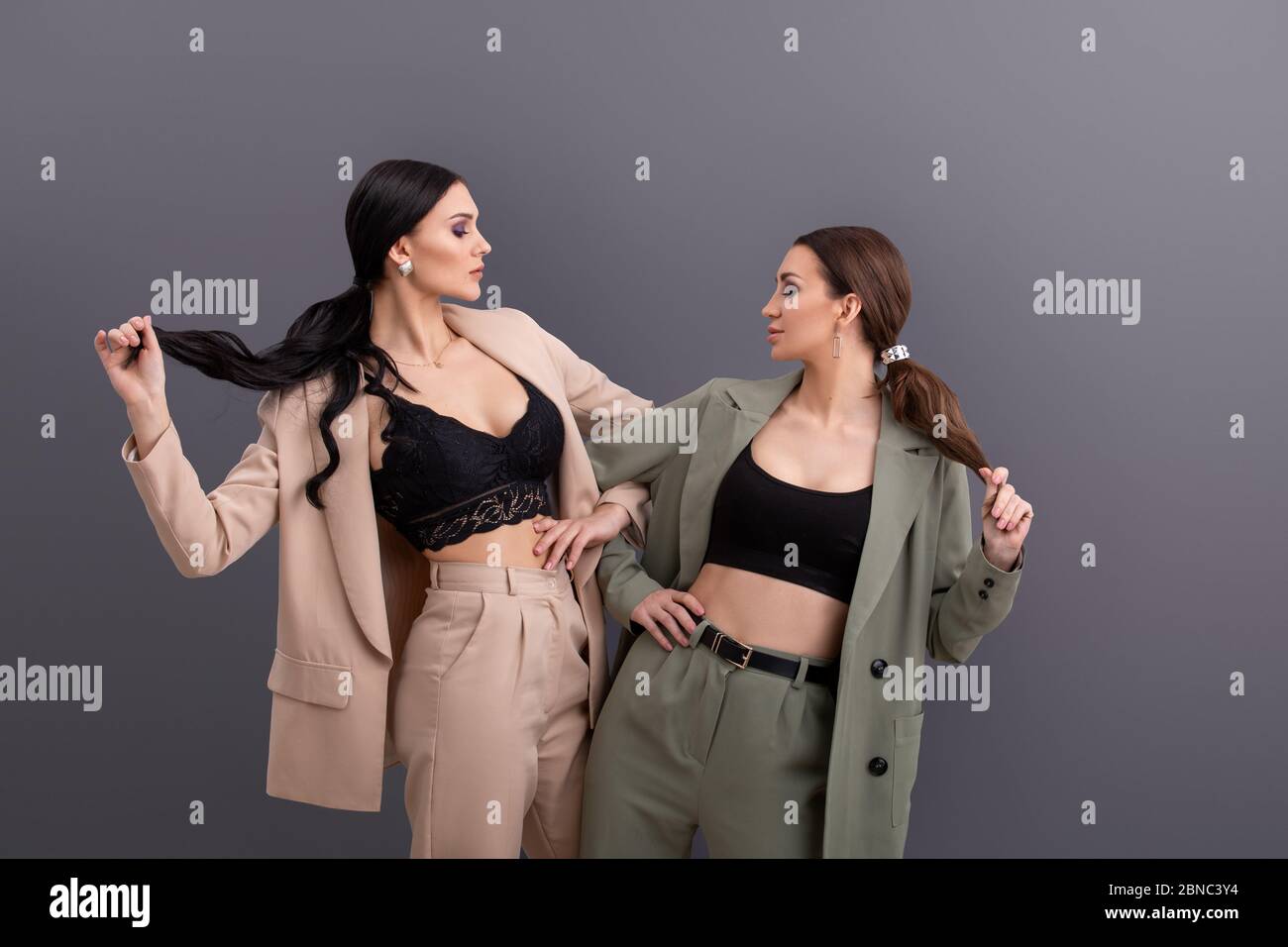 portrait of Two attractive business women wearing in suits and tops ...