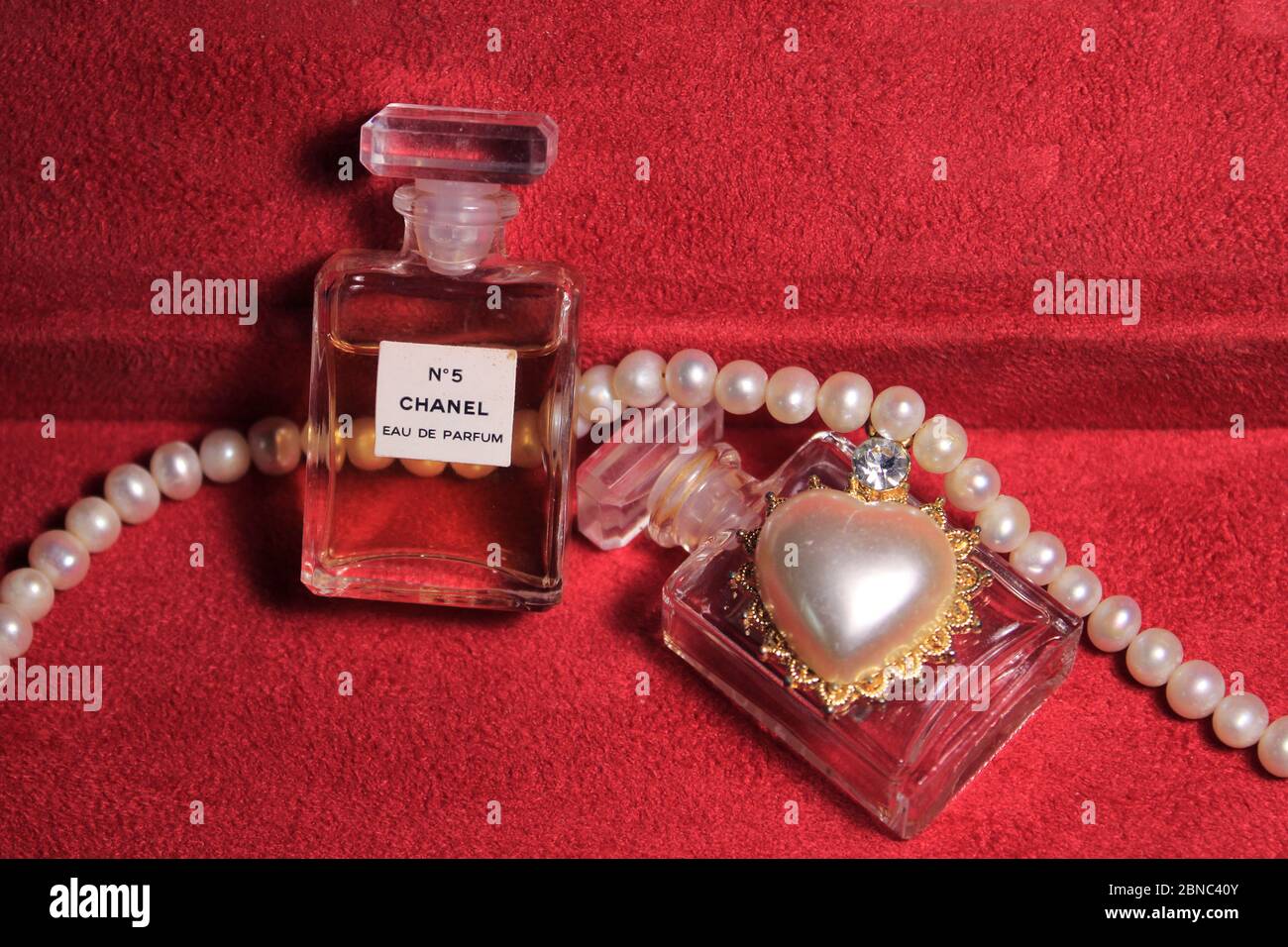 Chanel Perfume Bottles Isolated on Red Background. Bottles with