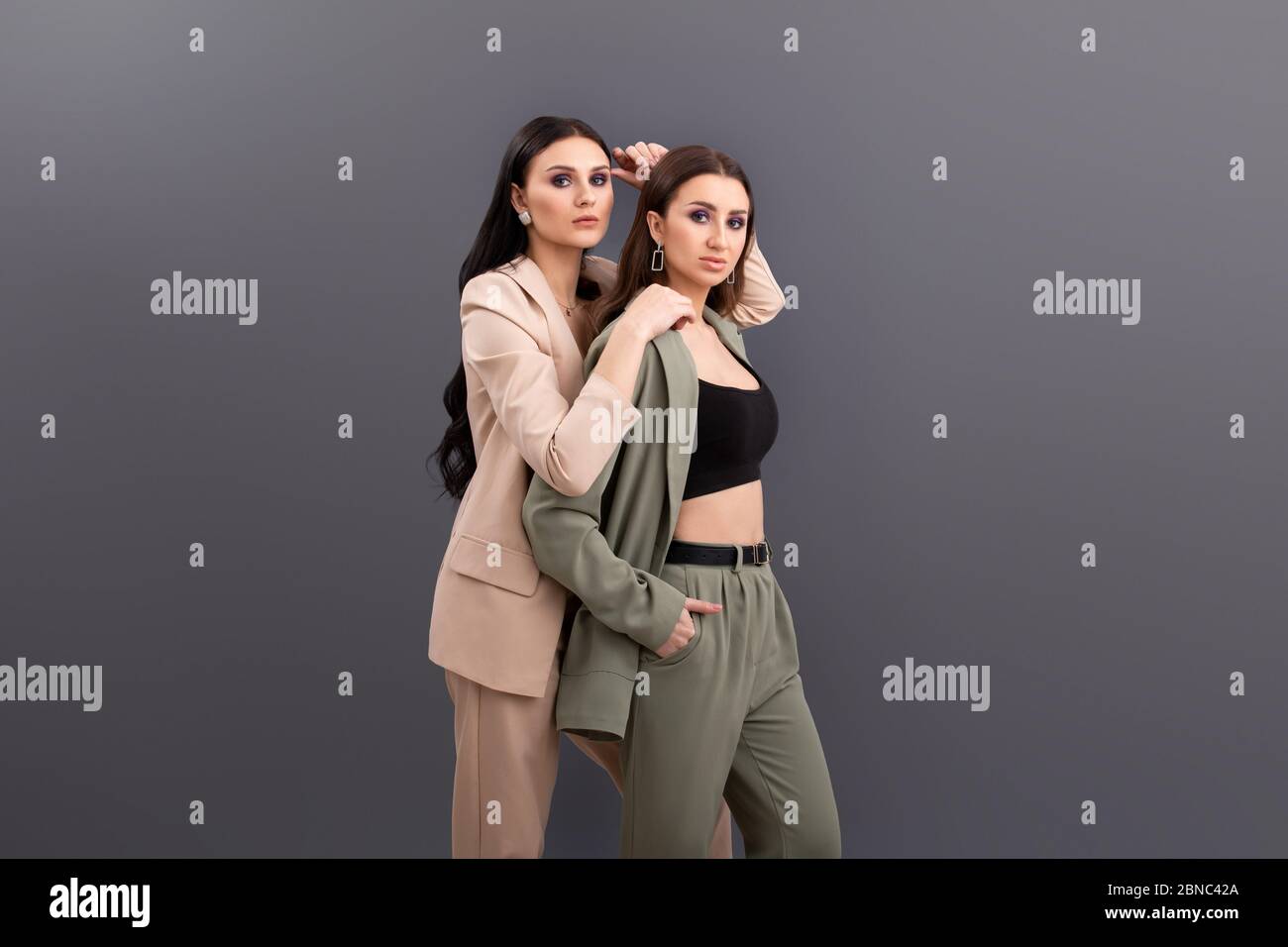 portrait of Two attractive business women wearing in suits and tops ...