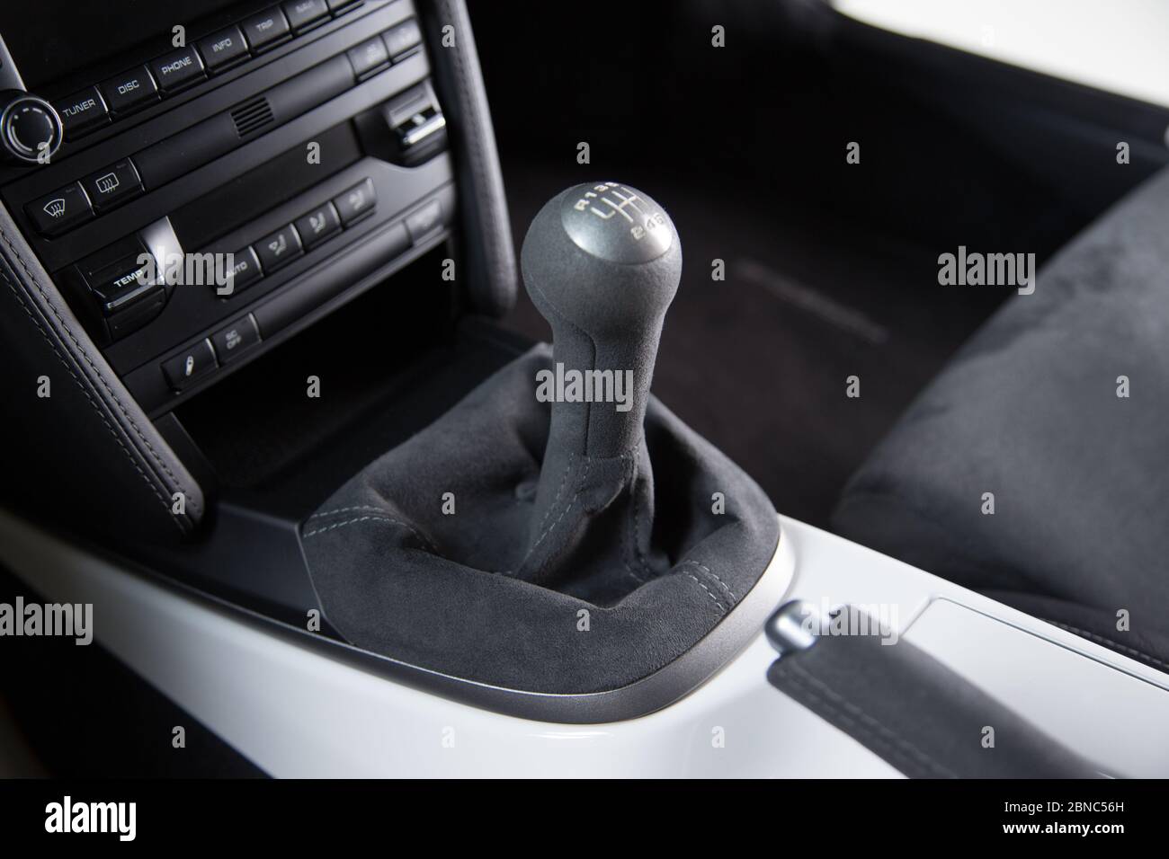 Closeup of the gear shift and control buttons of a modern car under the